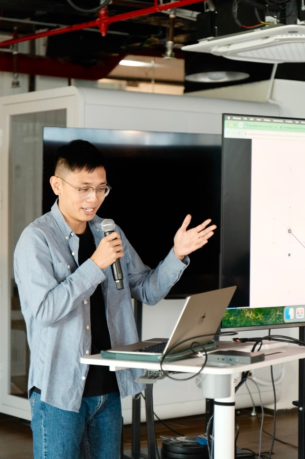 Tony speaking into a microphone during a live calibration workshop.