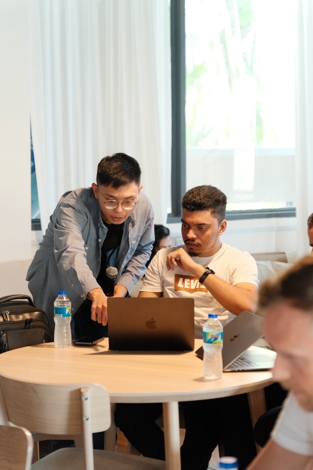 Workshop participants discussing a calibration exercise at a table.