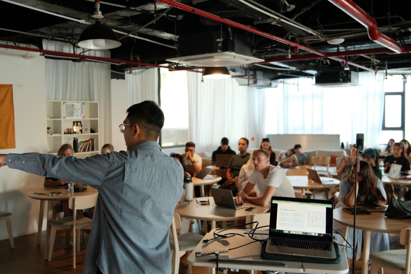 Tony facilitating a workshop with participants seated across the room.
