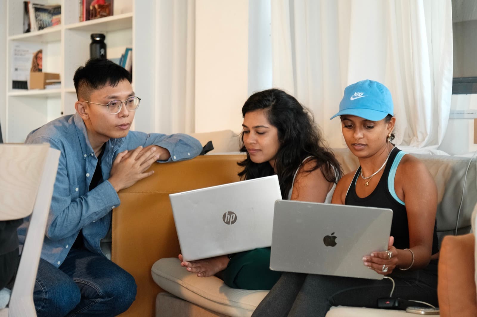 Tony working with a small group of participants around a laptop.