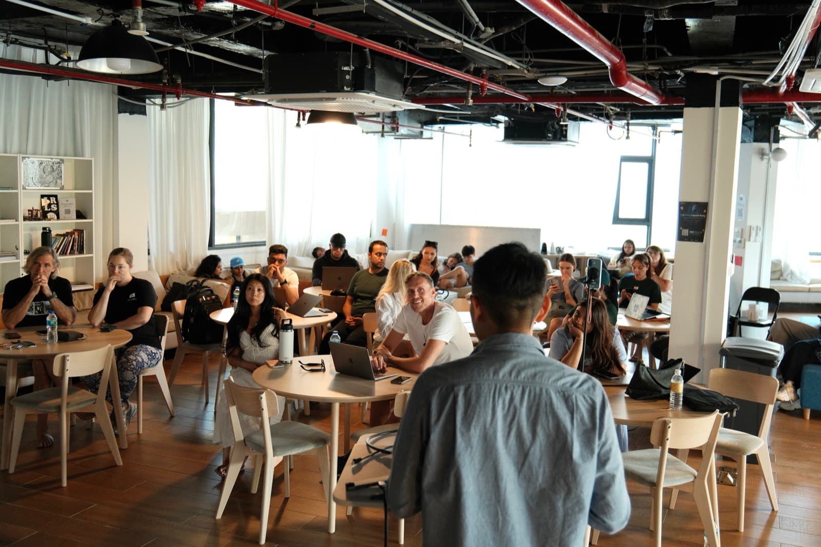 Tony facilitating a live calibration workshop with participants seated around the room.