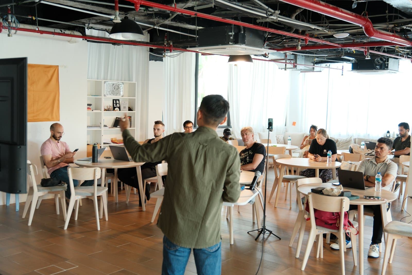 Tony facilitating a founder workshop with participants seated around the room.